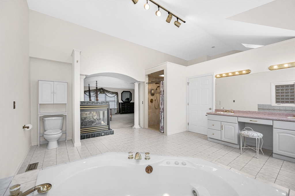 454 Dunstable Road Tyngsborough, MA 01879 - Photo 23 of 41 a large white bathroom with a sink a toilet and a bathtub