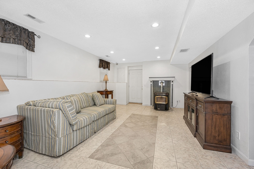 454 Dunstable Road Tyngsborough, MA 01879 - Photo 25 of 41 a living room with furniture and a flat screen tv