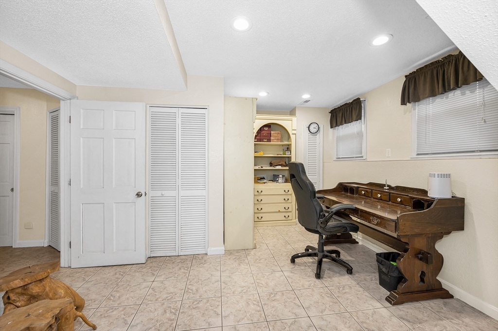 454 Dunstable Road Tyngsborough, MA 01879 - Photo 30 of 41 a view of a livingroom with workspace and a couch