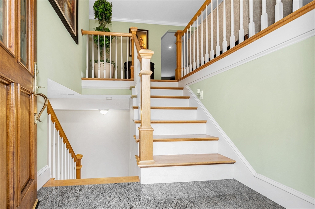 454 Dunstable Road Tyngsborough, MA 01879 - Photo 34 of 41 a view of staircase with lots of frames on wall and windows