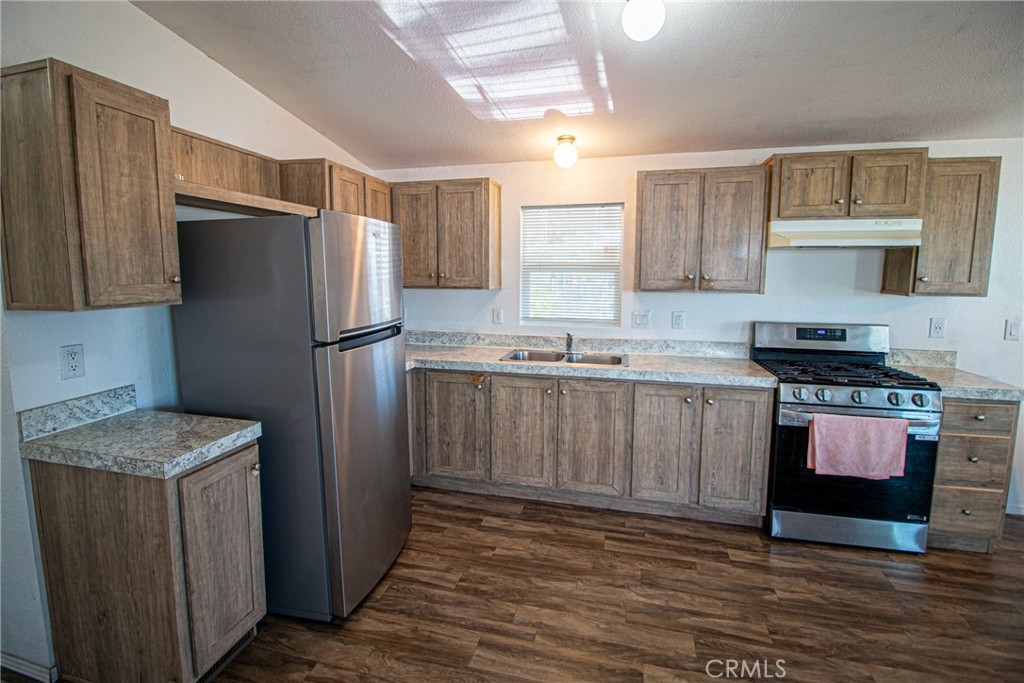 4444 East Ave R, Unit 202 Palmdale, CA 93552 - Photo 11 of 23 a kitchen with stainless steel appliances granite countertop a refrigerator stove and sink
