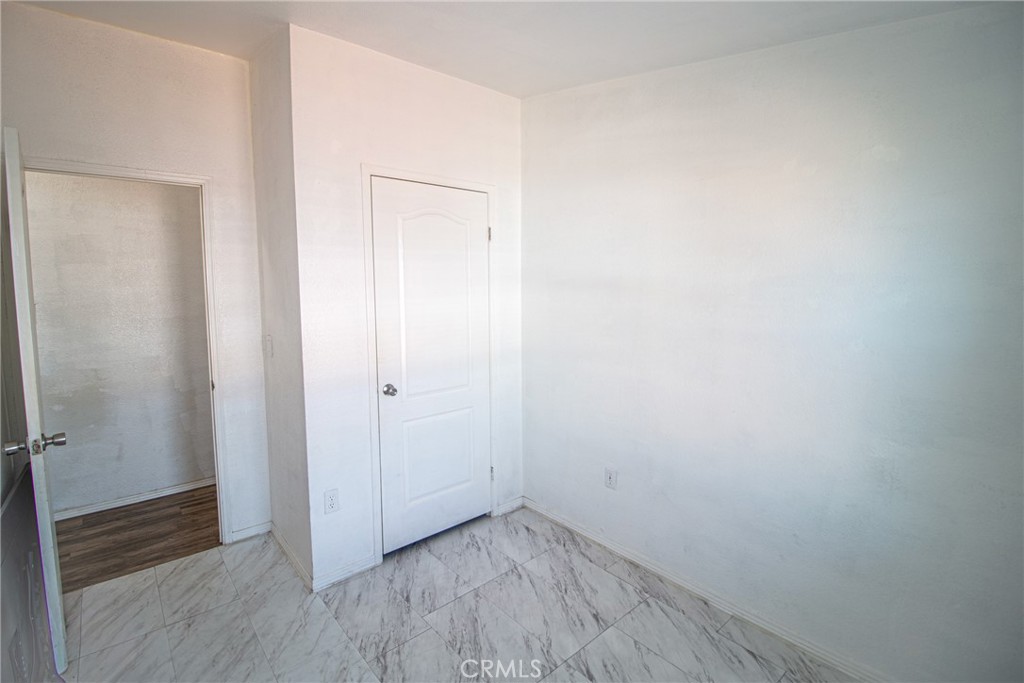 4444 East Ave R, Unit 202 Palmdale, CA 93552 - Photo 14 of 23 a view of an empty room with wooden floor