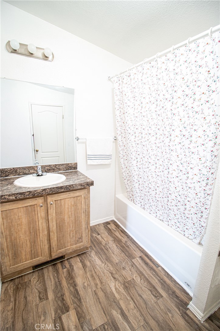 4444 East Ave R, Unit 202 Palmdale, CA 93552 - Photo 21 of 23 a bathroom with a granite countertop sink and a mirror