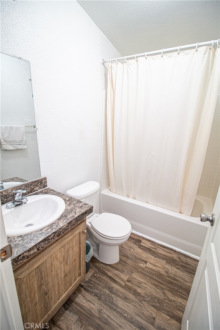 4444 East Ave R, Unit 202 Palmdale, CA 93552 - Photo 22 of 23 a bathroom with a granite countertop sink toilet and shower