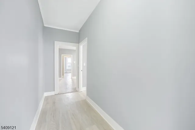 a view of a kitchen with wooden floor and a sink