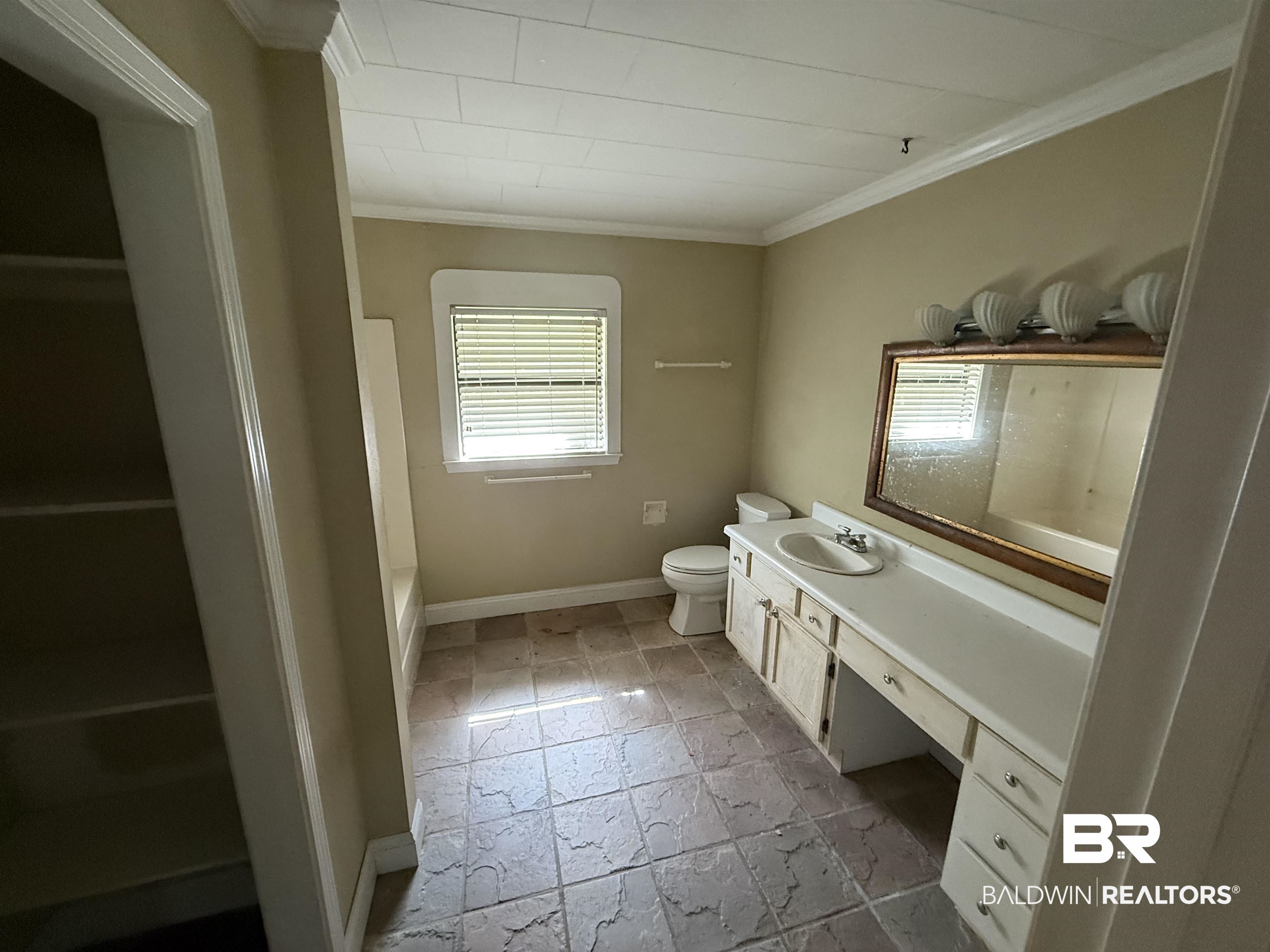 18743 Keller Road Foley, AL 36535 - Photo 5 of 21 Full bath with vanity, crown molding, and light stone finish floors