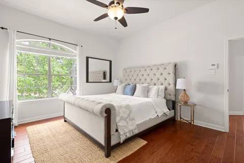 a large white bed sitting in a bedroom next to a window