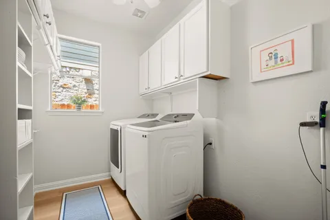 a view of storage and utility room with washer and dryer