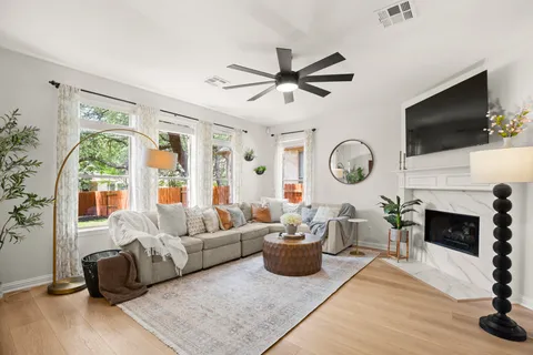 a living room with furniture a fireplace and a flat screen tv