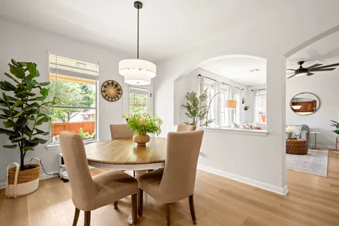 a view of a dining room with furniture window and wooden floor