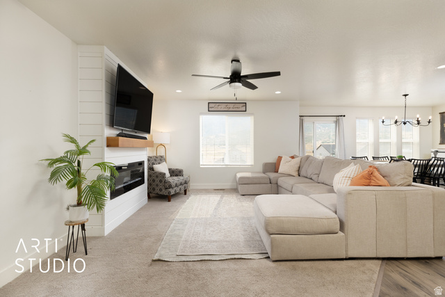 1713 South Windemere Road Santaquin, UT 84655 - Photo 5 of 40 Open-concept living space featuring a shiplap accent wall with a built-in electric fireplace and a wood mantel