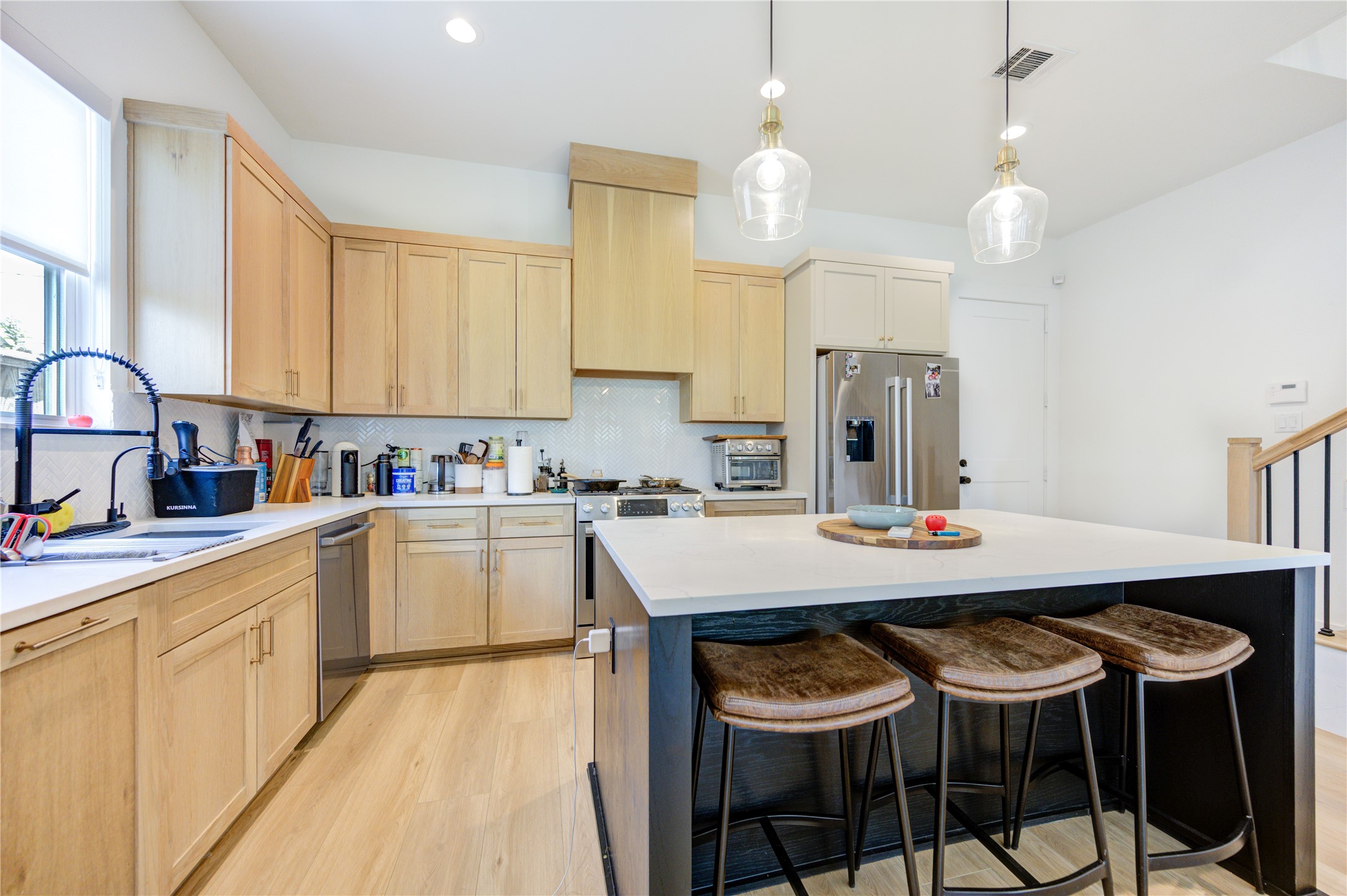 18 Sidney Street, Unit A Houston, TX 77003 - Photo 11 of 30 a kitchen with cabinets and chairs