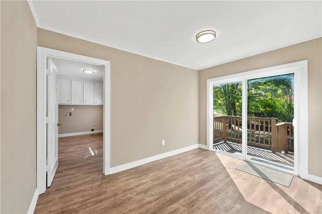 a view of a room with wooden floor and window
