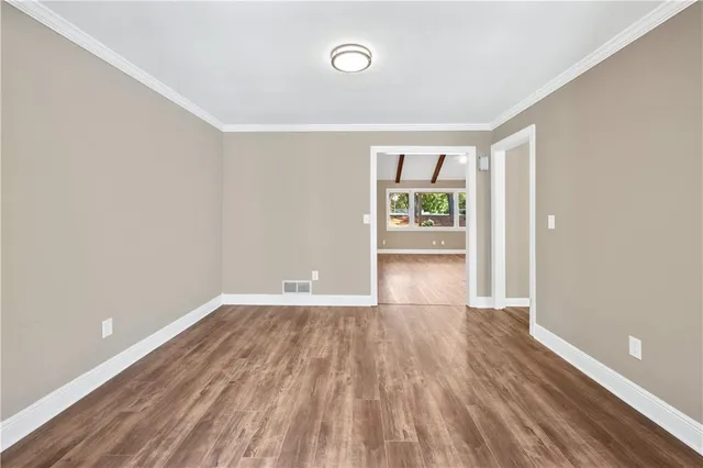 wooden floor in an empty room with a window