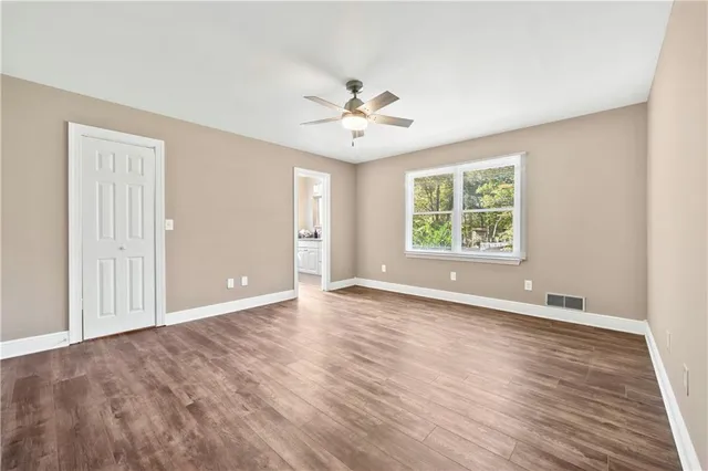 wooden floor in an empty room with a window