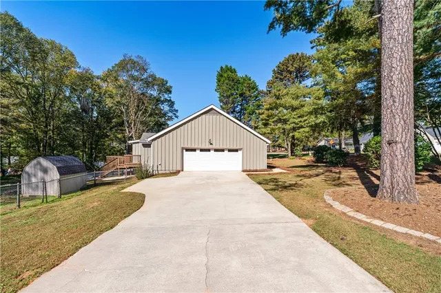 a view of house with yard and trees in the background