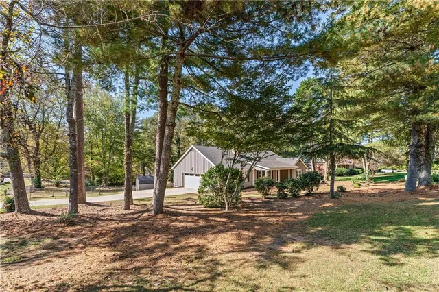 a view of house with outdoor space and tree s