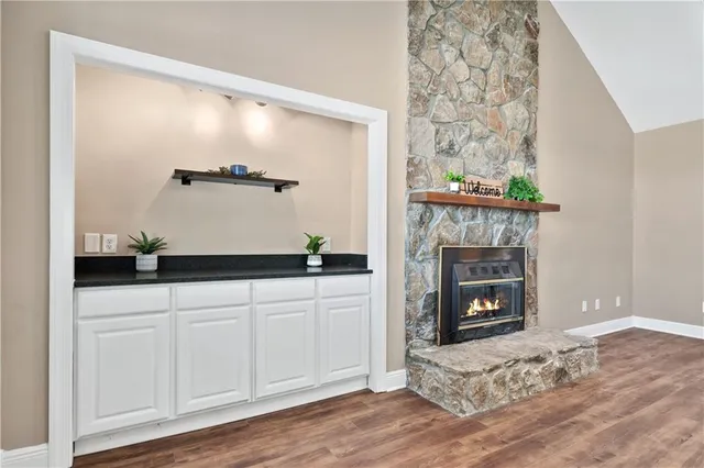 a spacious bathroom with a granite countertop sink and a mirror