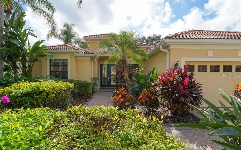 6732 The Masters Avenue Lakewood Ranch, FL 34202 - Photo 1 of 1 a front view of a house with a yard