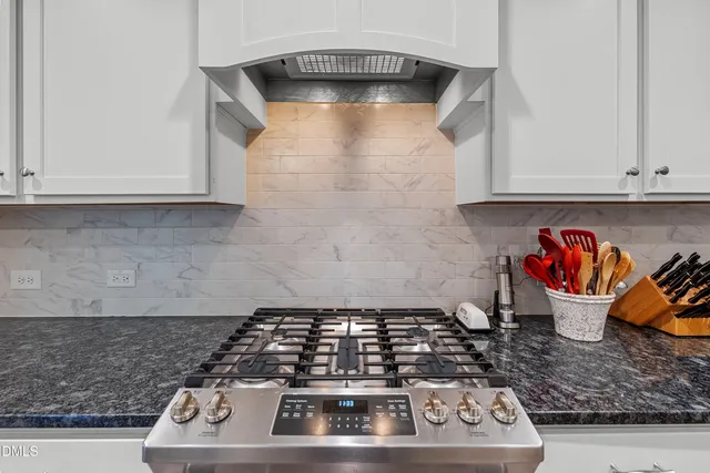 a kitchen with a stove and cabinets