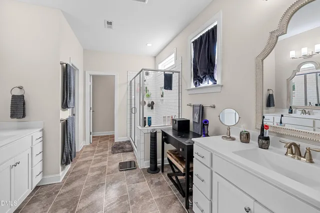 a bathroom with a shower and a sink