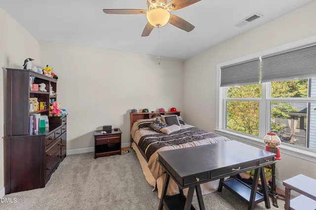 a bedroom with a bed and a book shelf