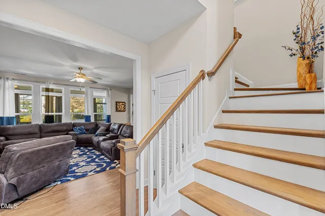 a living room with furniture and stairs