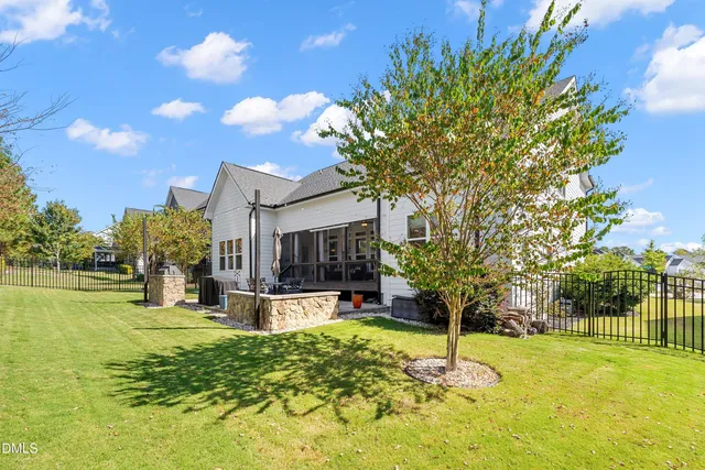 an aerial view of a house with swimming pool garden and patio