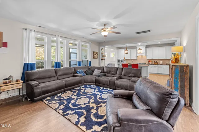 a living room with furniture and kitchen view