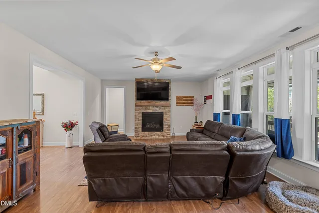 a living room with furniture a fireplace and a flat screen tv