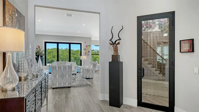 a living room with furniture potted plant and a large window