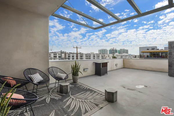 a room with stainless steel appliances living room furniture and a view of kitchen