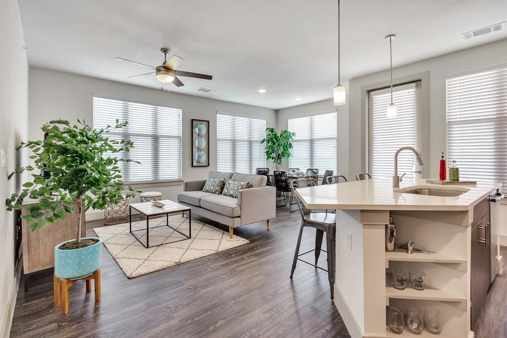 10550 North Central Expressway, Unit 161 Dallas, TX 75231 - Photo 1 of 9 a living room with furniture a chandelier and a potted plant