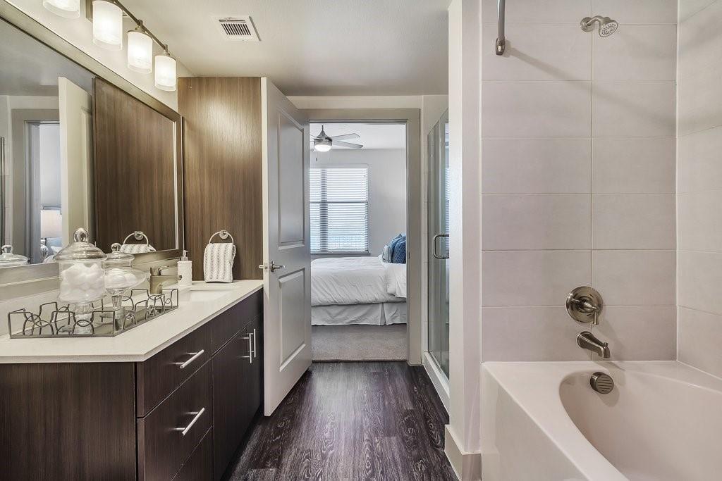 10550 North Central Expressway, Unit 161 Dallas, TX 75231 - Photo 3 of 9 a spacious bathroom with a tub sink and mirror