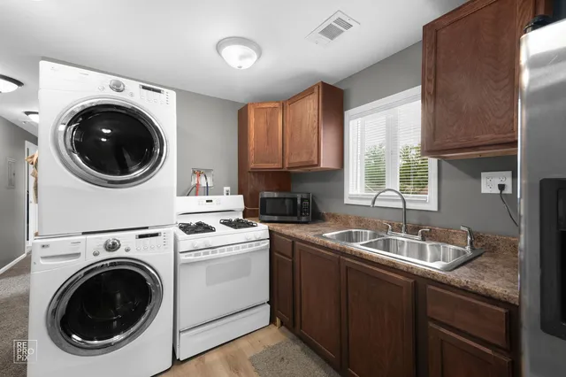 a kitchen with a sink a washer and dryer