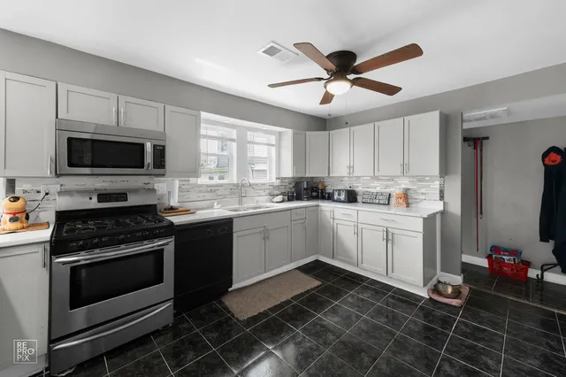 a kitchen with a stove cabinets and window
