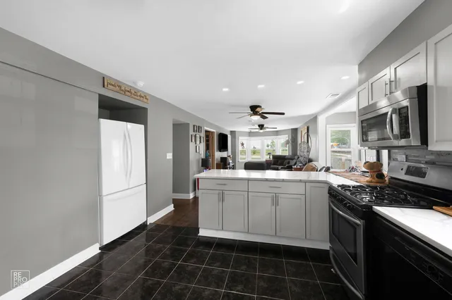 a kitchen with stainless steel appliances a sink stove and refrigerator