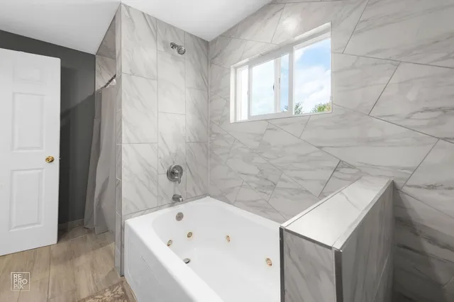 a bathroom with a bathtub and a sink