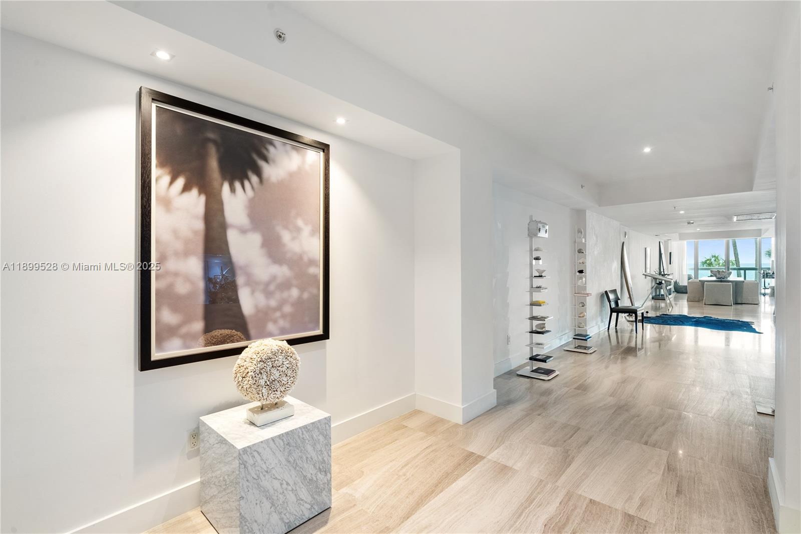 6899 Collins Avenue, Unit 202 Miami Beach, FL 33141 - Photo 9 of 18 a living room with furniture and a large window