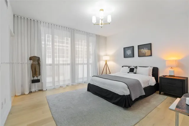 a bedroom with a bed and a chandelier