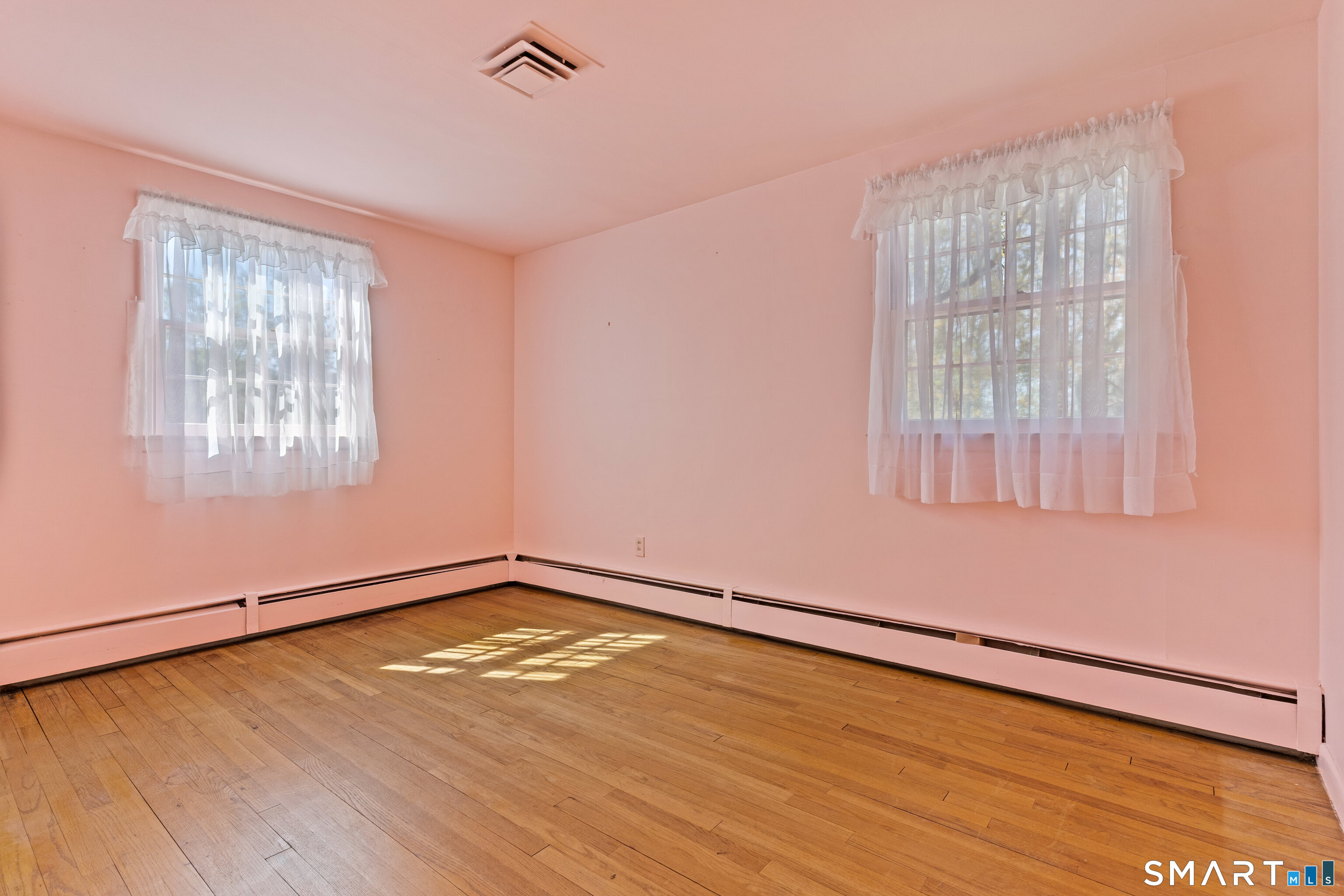 251 Shelter Rock Road Fairfield, CT 06825 - Photo 26 of 38 an empty room with wooden floor and windows