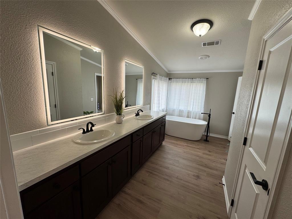131 Lipan Trail Weatherford, TX 76087 - Photo 14 of 25 a bathroom with a double vanity sink and mirror