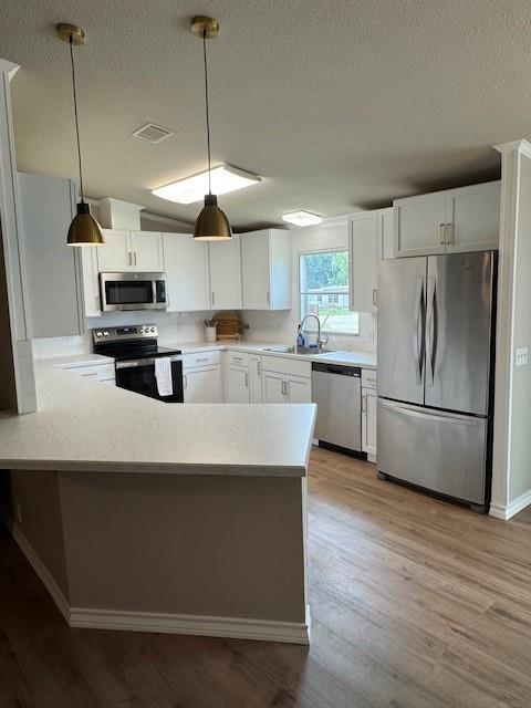 131 Lipan Trail Weatherford, TX 76087 - Photo 6 of 25 a kitchen with kitchen island a refrigerator a stove a microwave and wooden floor