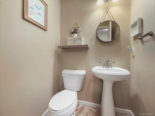 a white toilet sitting next to a bathroom sink