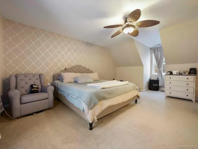 a bedroom with a bed furniture and ceiling fan
