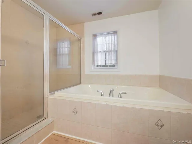 a bathroom with a bathtub and a sink