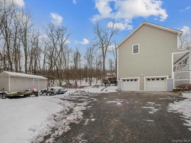 a view of a house with a yard covered in snow