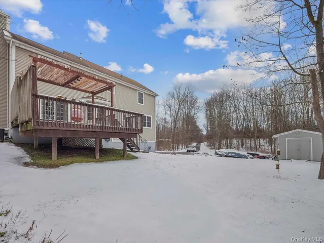 a backyard of a house with barbeque oven and outdoor seating