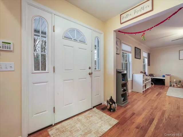 a view of a livingroom with hardwood floor and hallway