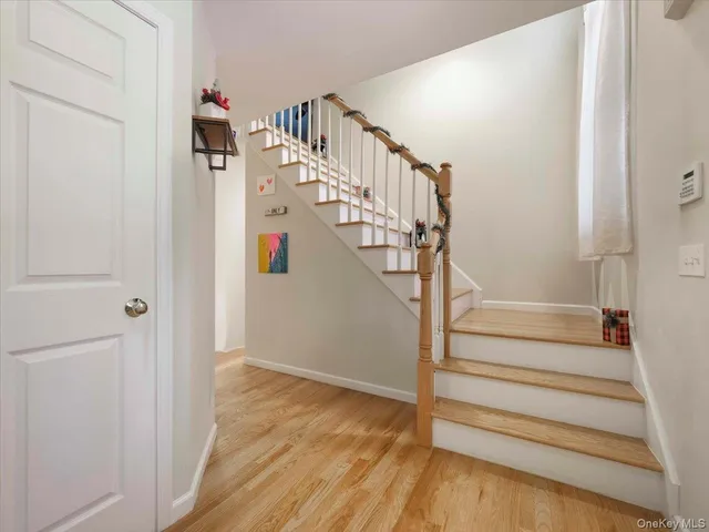 a view of entryway and hall with wooden floor